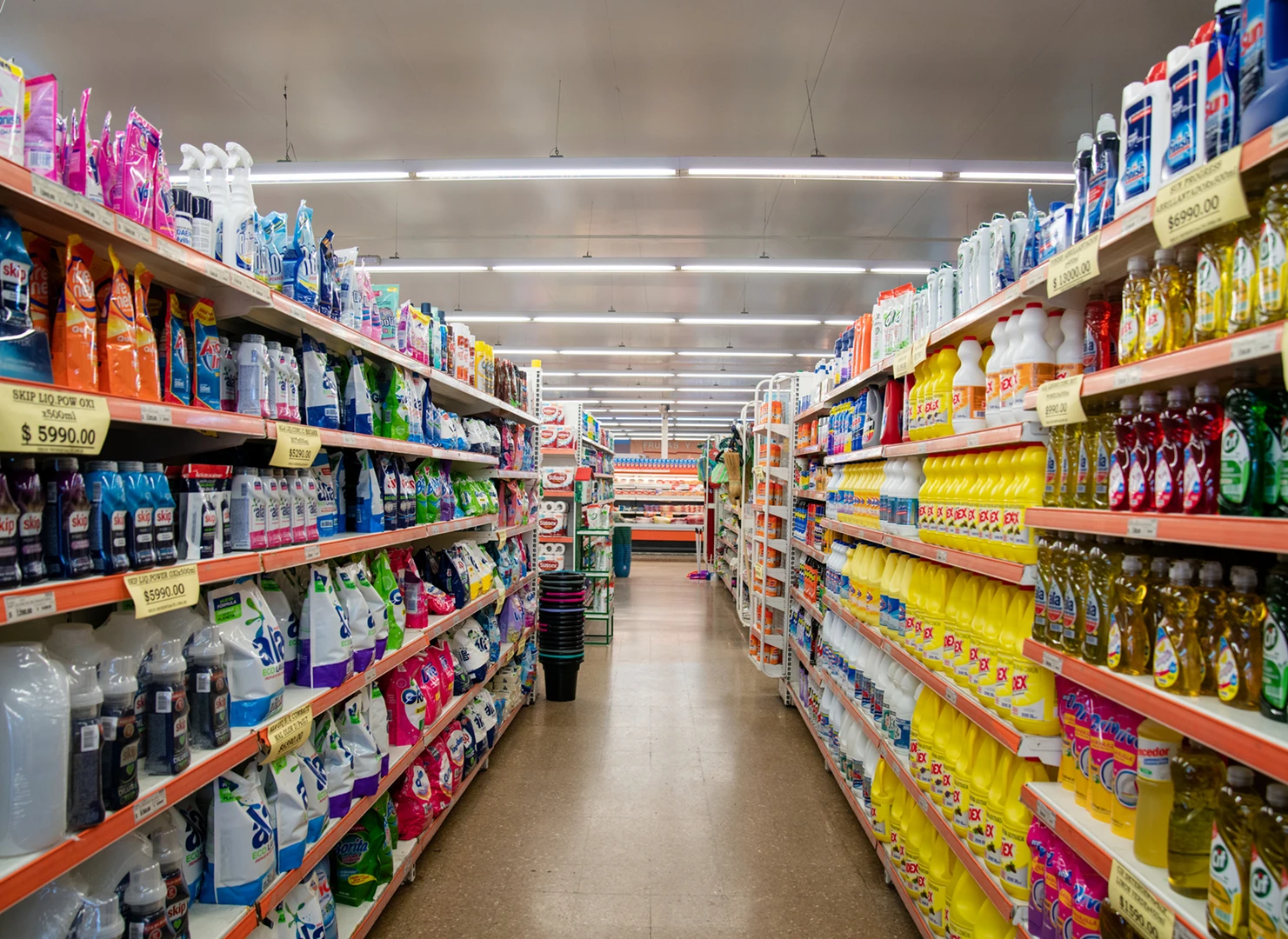 Supermarket aisle with cleaning products displayed.
